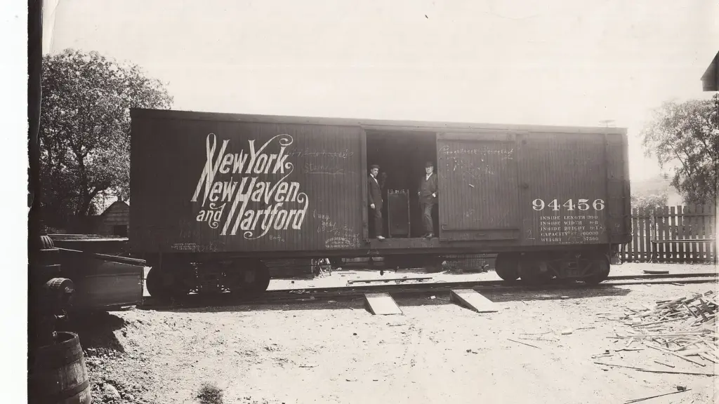 Thomas Edison with a railroad car carrying a shipment of Edison storage batteries