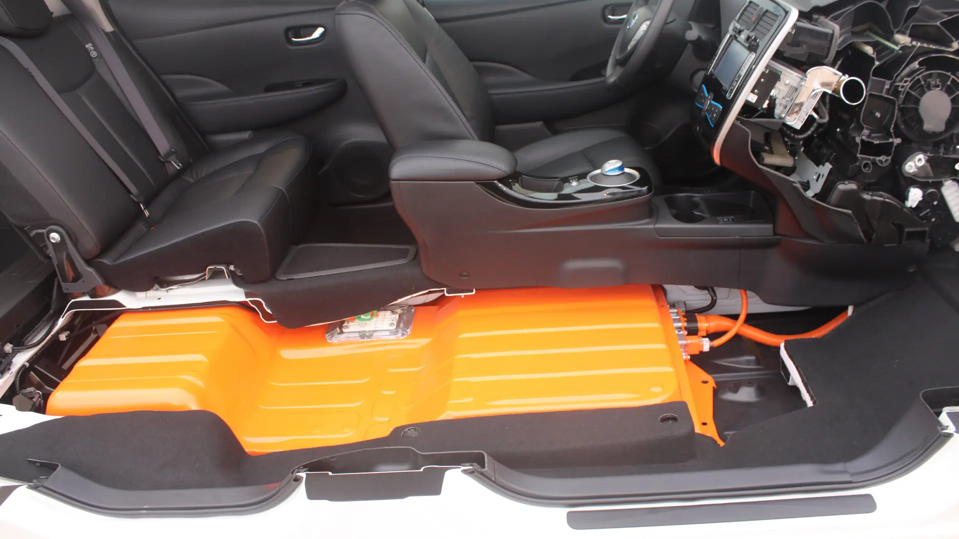 Cutaway of an electric car showing the flat battery pack under the floor