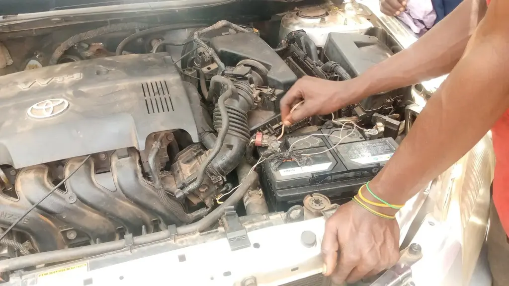 Mechanic testing a 12-volt car battery