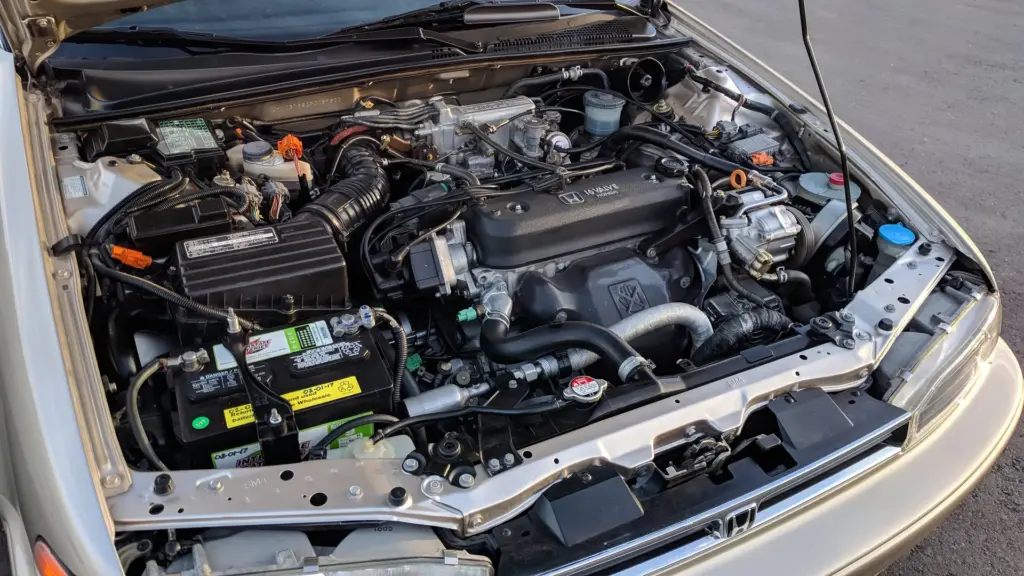 Four-cylinder gasoline engine in the engine bay of a sedan