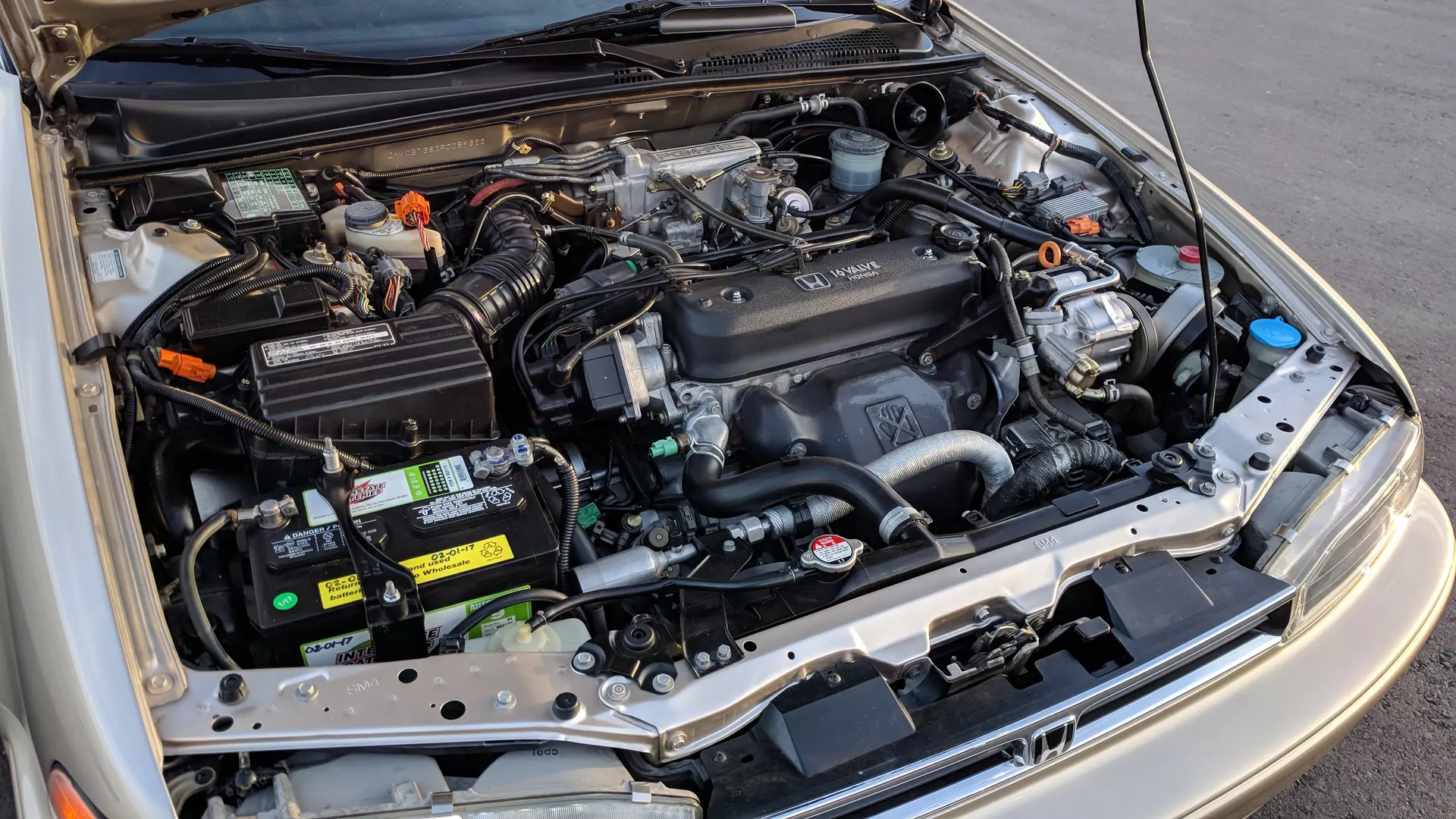 Four-cylinder gasoline engine in the engine bay of a sedan