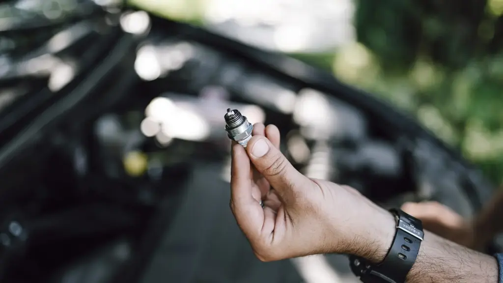Mechanic changing a fuel injector on a car engine