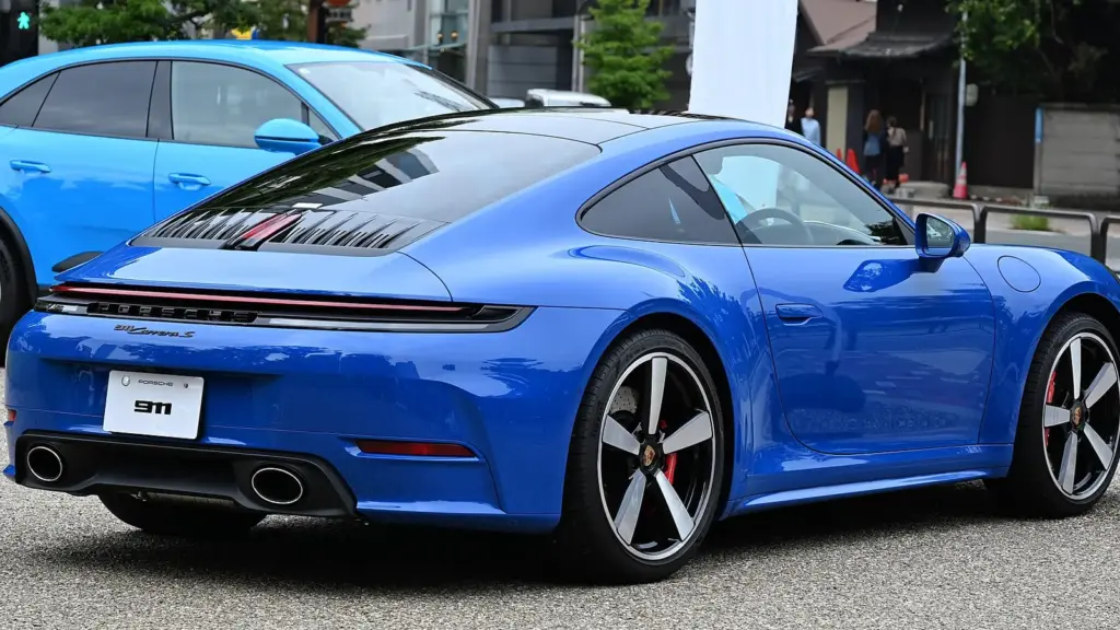 Blue Porsche 911 Carrera S coupe of the 992.2 generation, seen from the rear
