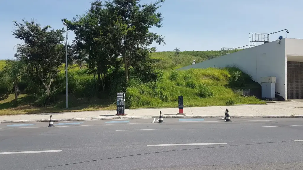 Service station with fuel pumps and electric vehicle chargers side by side