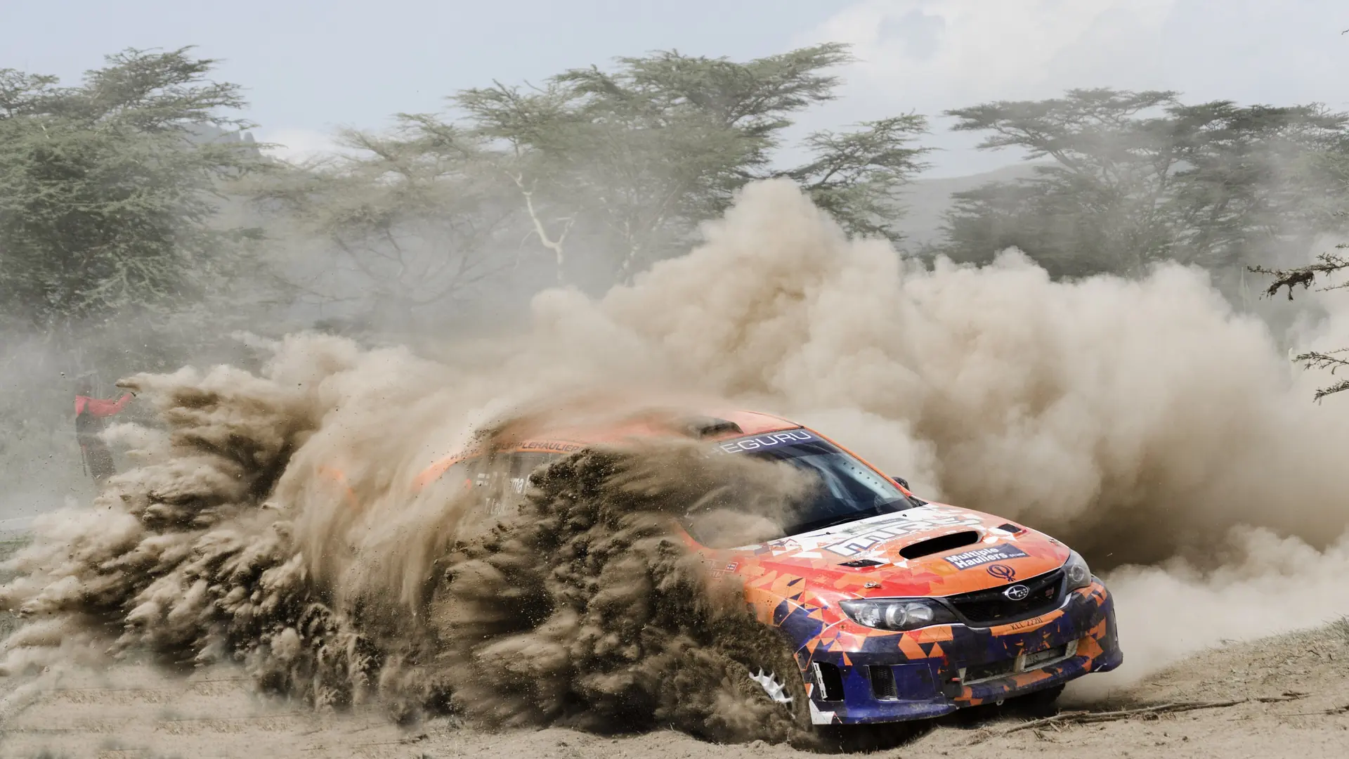 A rally car throws up dust on a gravel stage near Naivasha, Kenya, the home of the Safari Rally