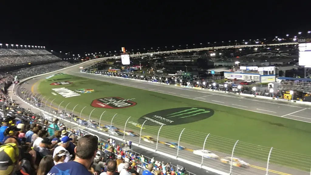 NASCAR Cup cars racing under the lights at Daytona International Speedway