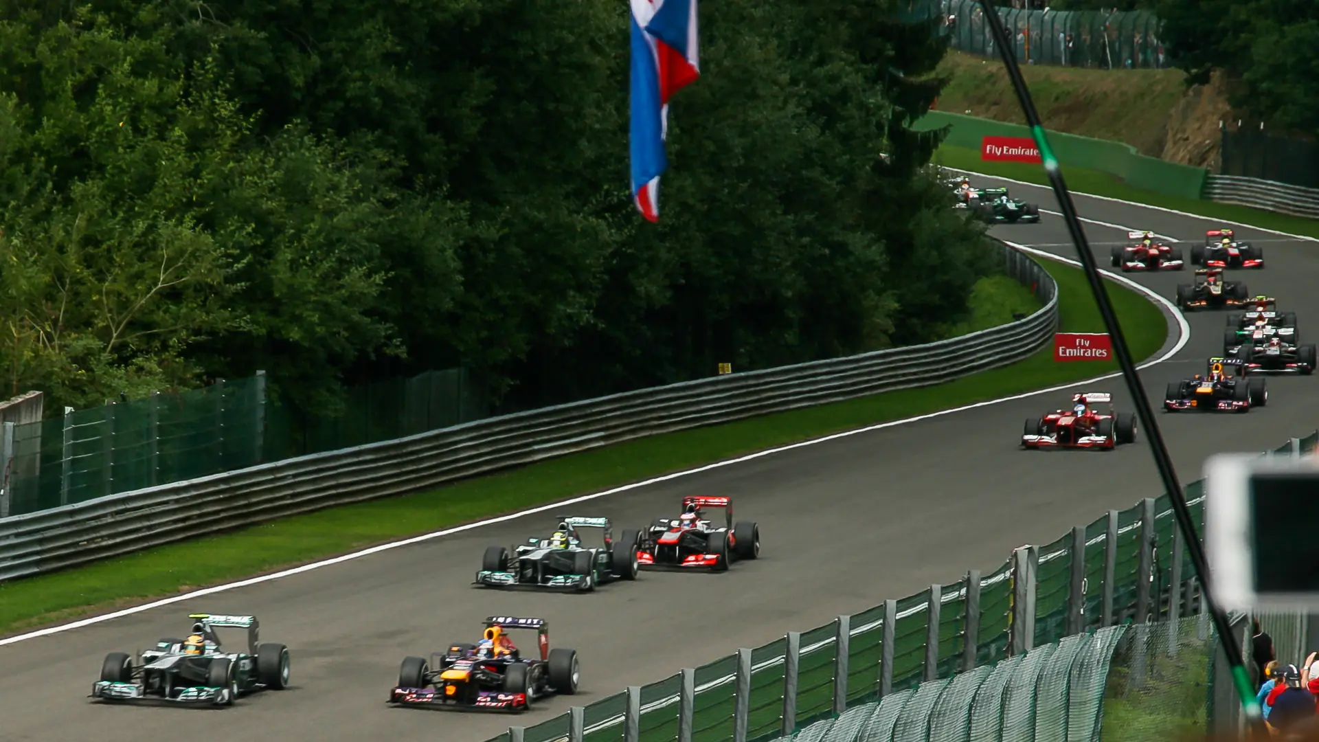 Formula 1 field climbing out of Eau Rouge on the opening lap of the Belgian Grand Prix at Spa-Francorchamps