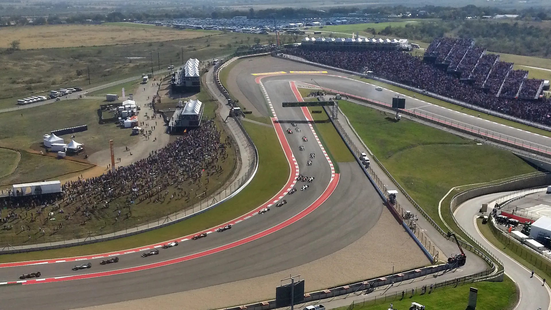 Formula 1 cars racing through the turns after the start of the United States Grand Prix at Circuit of the Americas in Austin, Texas