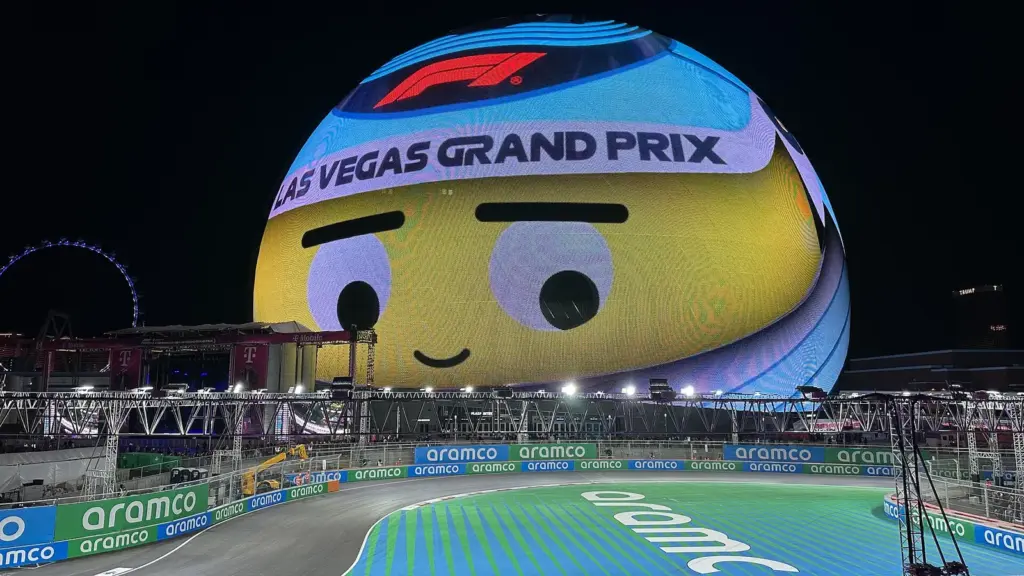 Night-time Formula 1 track beside the Sphere at the Las Vegas Grand Prix