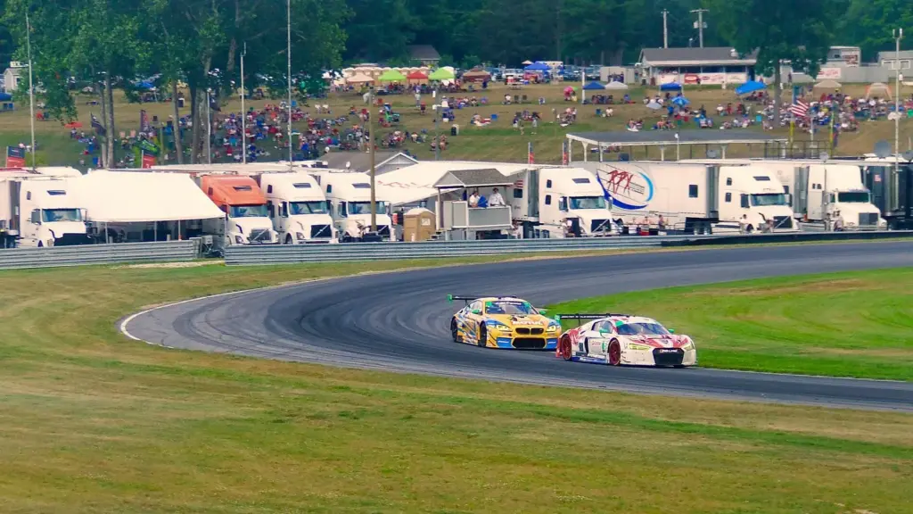 GT3 cars battling through the Left Hander at Lime Rock Park in Connecticut