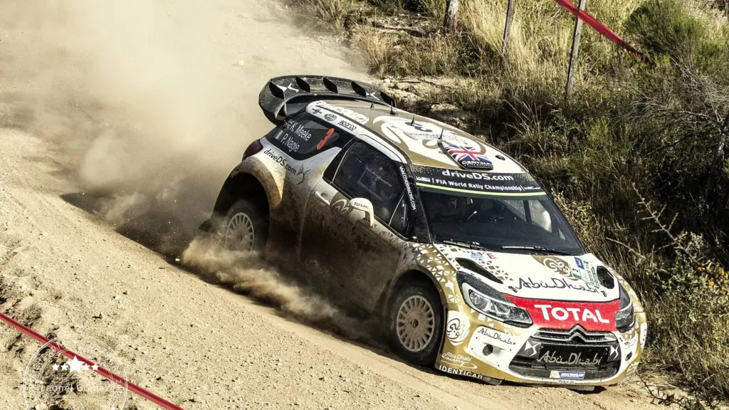 Citroën rally car kicking up dust on a gravel stage of Rally Argentina 2015 in Córdoba