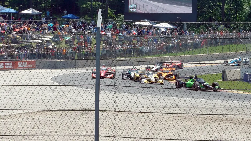 IndyCar race cars in a corner during the XPEL Grand Prix at Road America in Elkhart Lake, Wisconsin