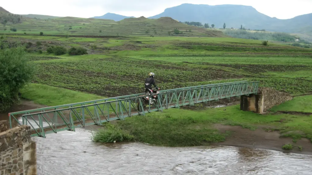 An enduro rider crosses a river bridge in the Lesotho highlands on day one of the Roof of Africa
