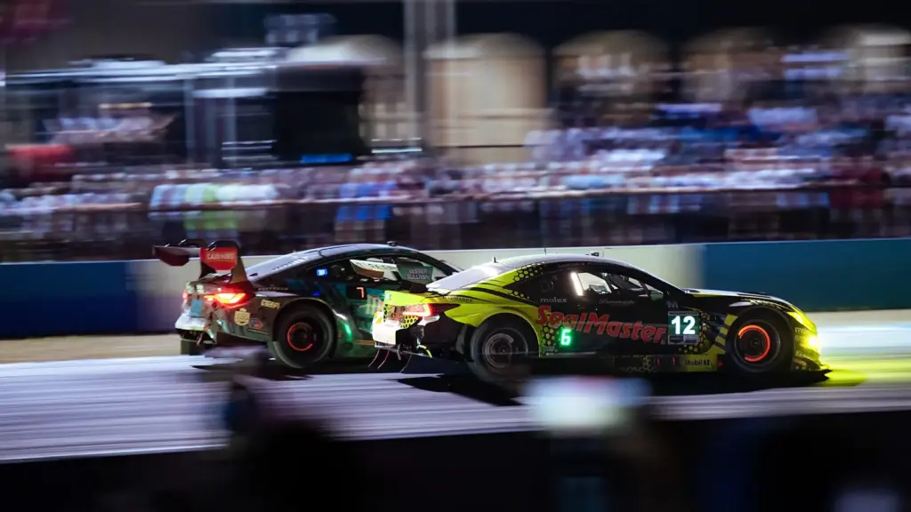 IMSA sports cars racing at night during the 12 Hours of Sebring in Florida