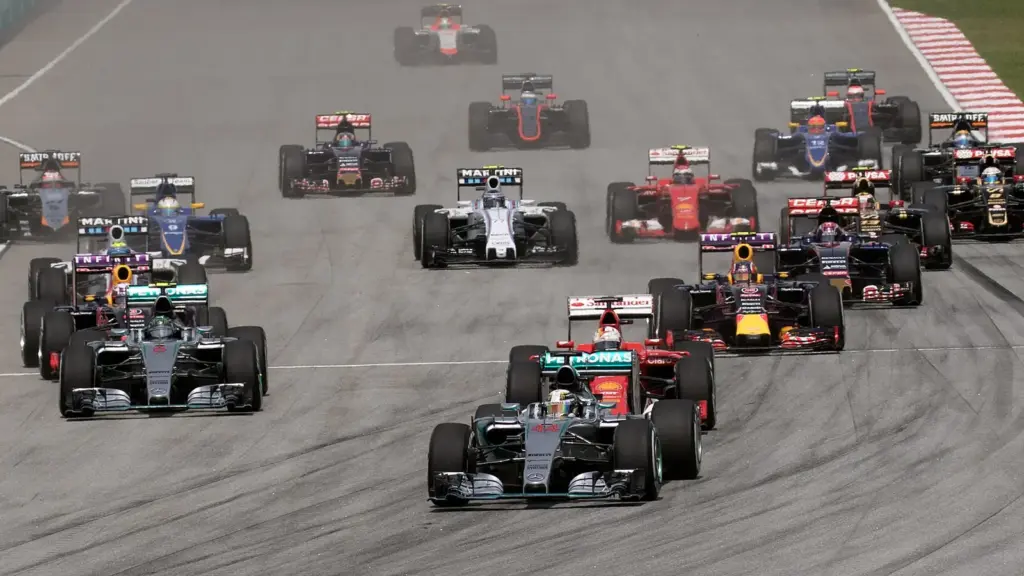 Formula 1 cars racing into a corner at Sepang International Circuit near Kuala Lumpur