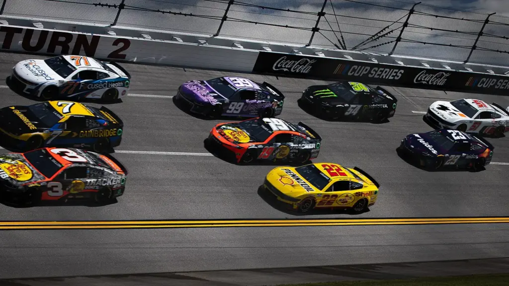 NASCAR Cup cars racing in a pack on the banking at Talladega Superspeedway in Alabama