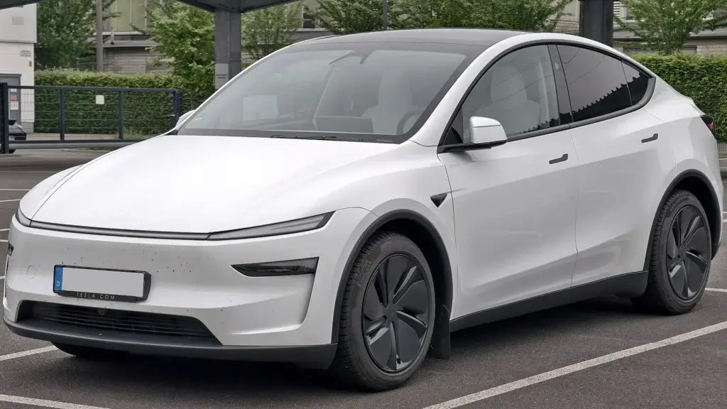 White Tesla Model Y Premium, the 2025 facelift, front three-quarter view
