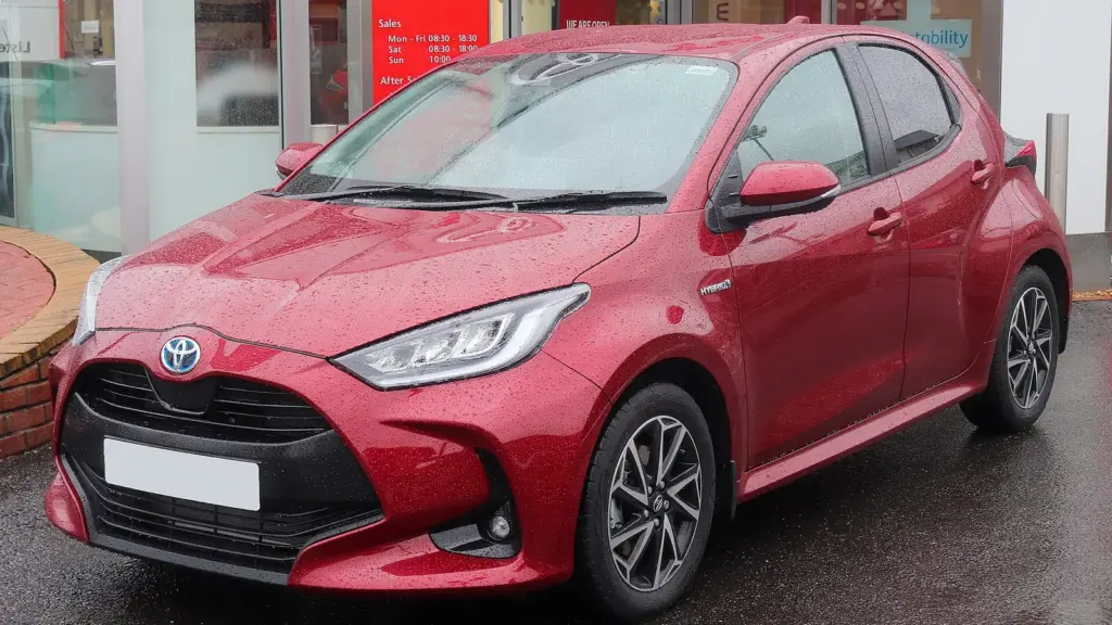 Red Toyota Yaris Hybrid hatchback photographed in Stratford-upon-Avon, England
