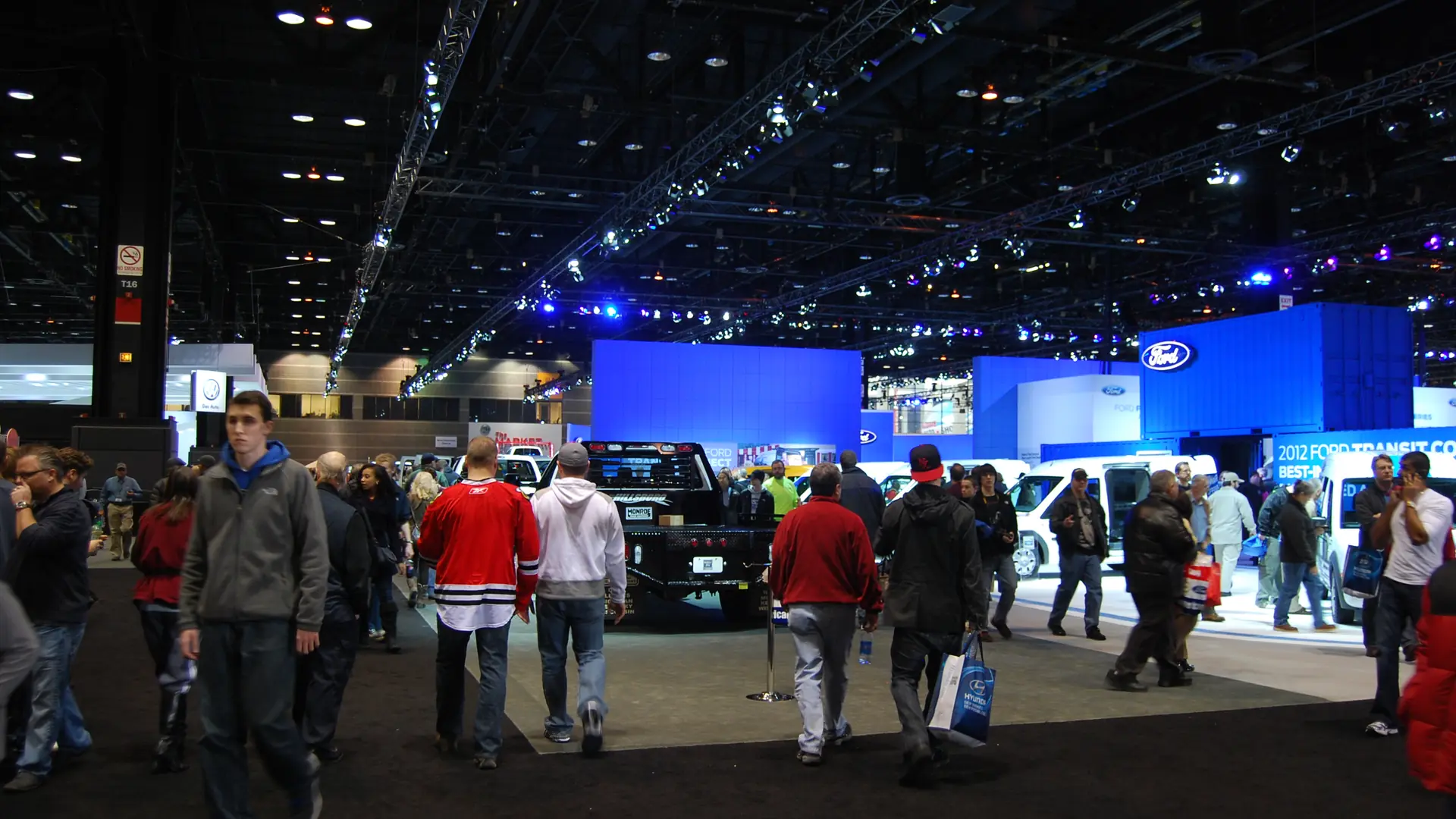 Shoppers looking at new cars and trucks on the floor of the Chicago Auto Show