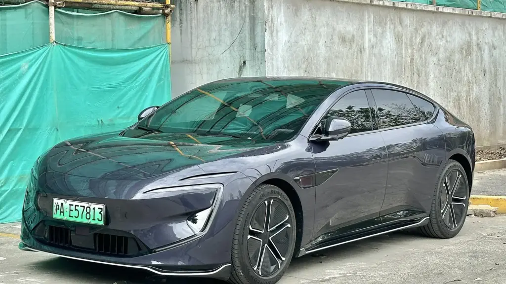 Gray Avatr 12 electric sedan parked by a construction site