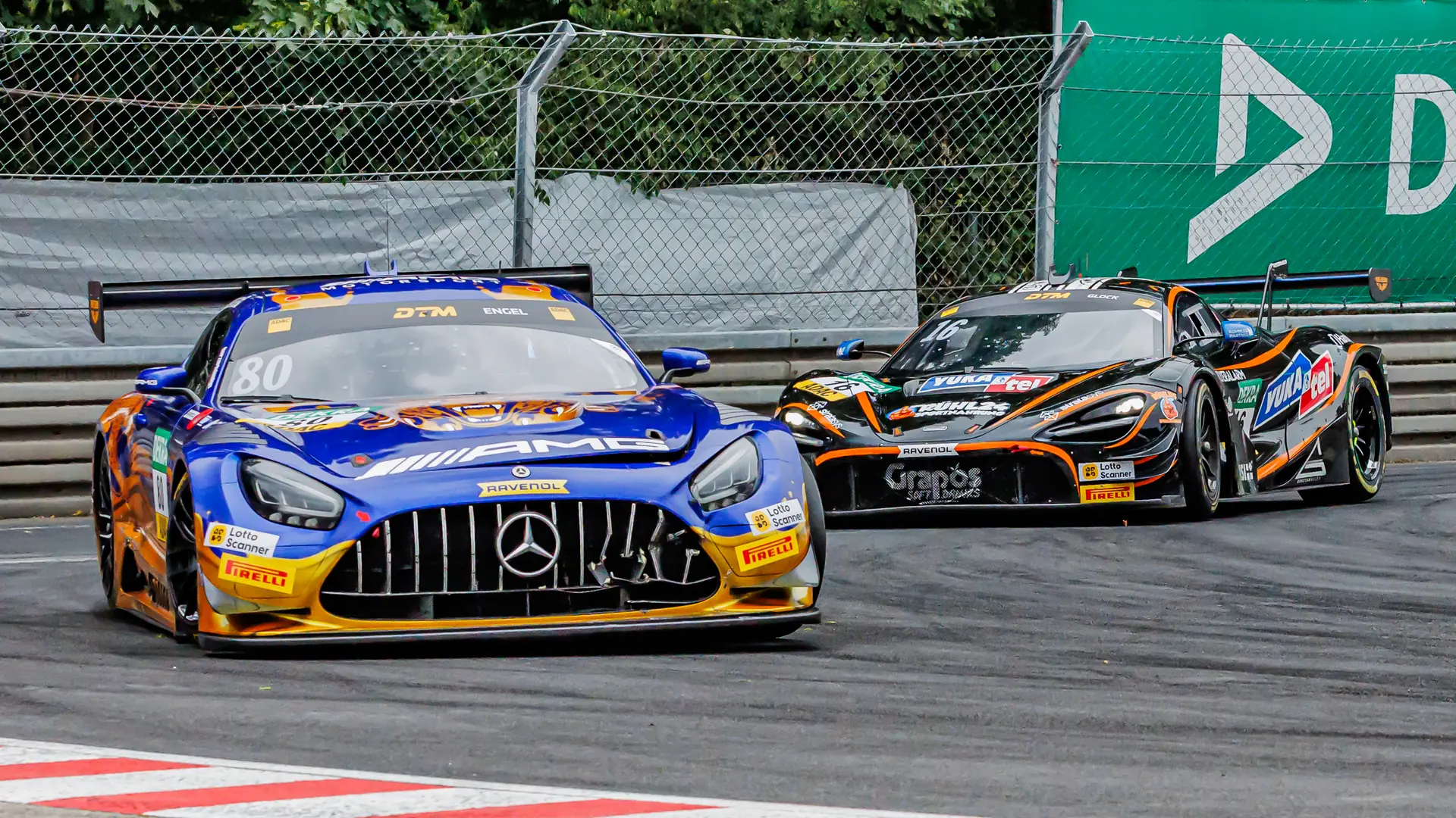 A Mercedes-AMG GT3 leads a McLaren GT3 through the Norisring street circuit during the 2026 DTM race weekend