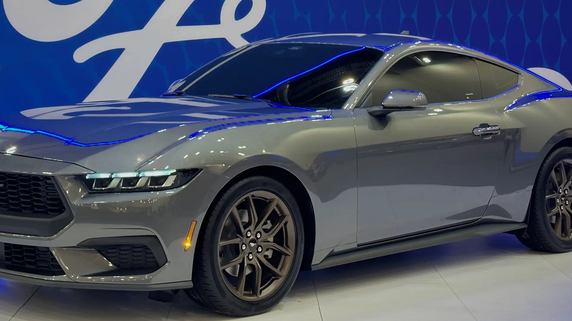 Grey seventh-generation 2024 Ford Mustang fastback, side view