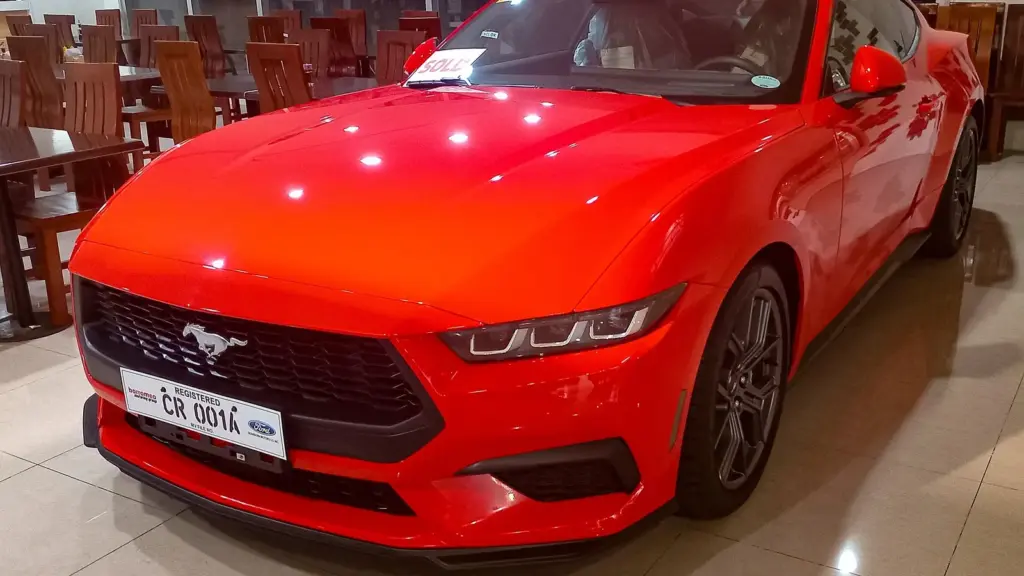2024 Ford Mustang 2.3 EcoBoost in Race Red, displayed at a Ford dealership in Muntinlupa, Philippines