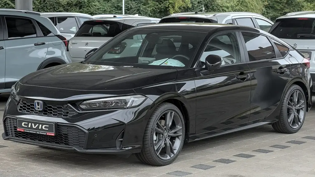 Black 2025 Honda Civic Hybrid hatchback with the facelifted front end, parked in Stuttgart
