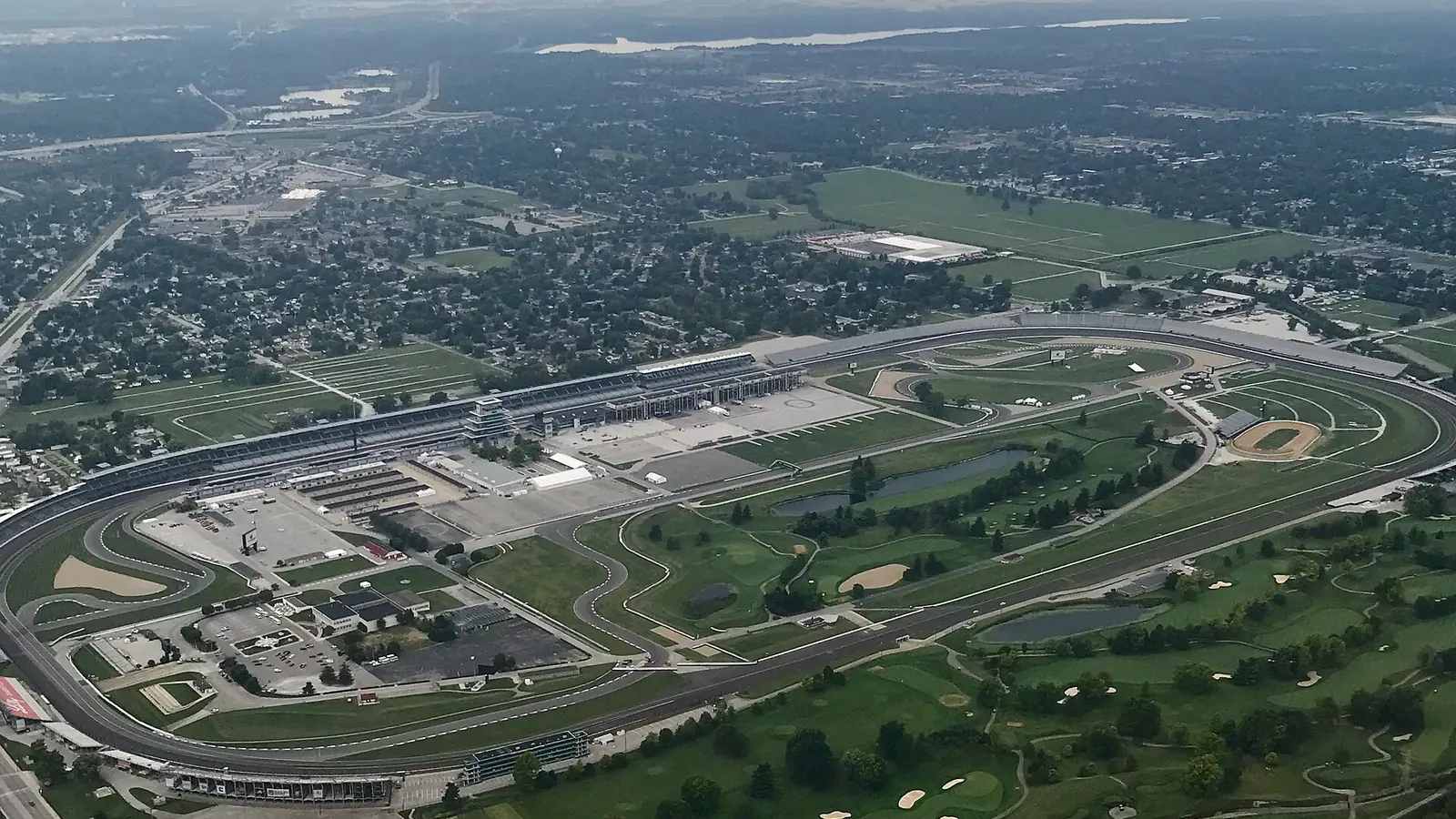 Aerial view of Indianapolis Motor Speedway looking northwest, with the 2.5-mile oval, grandstands and infield