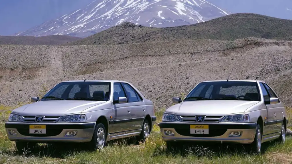 Two Peugeot Pars sedans in front of Mount Damavand