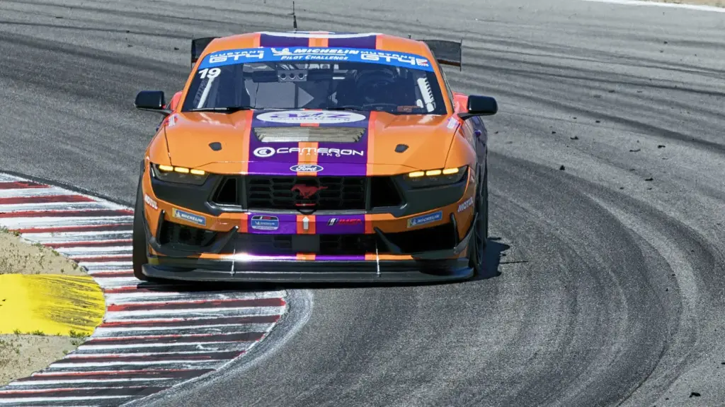 A Ford Mustang GT4 racing in IMSA at Laguna Seca in 2025