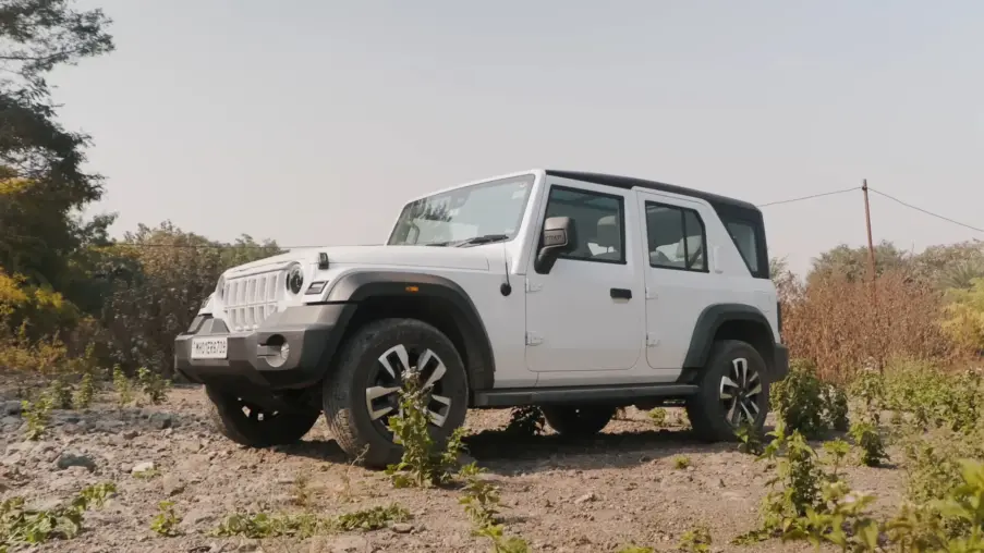 White Mahindra Thar Roxx five-door SUV on a dirt track