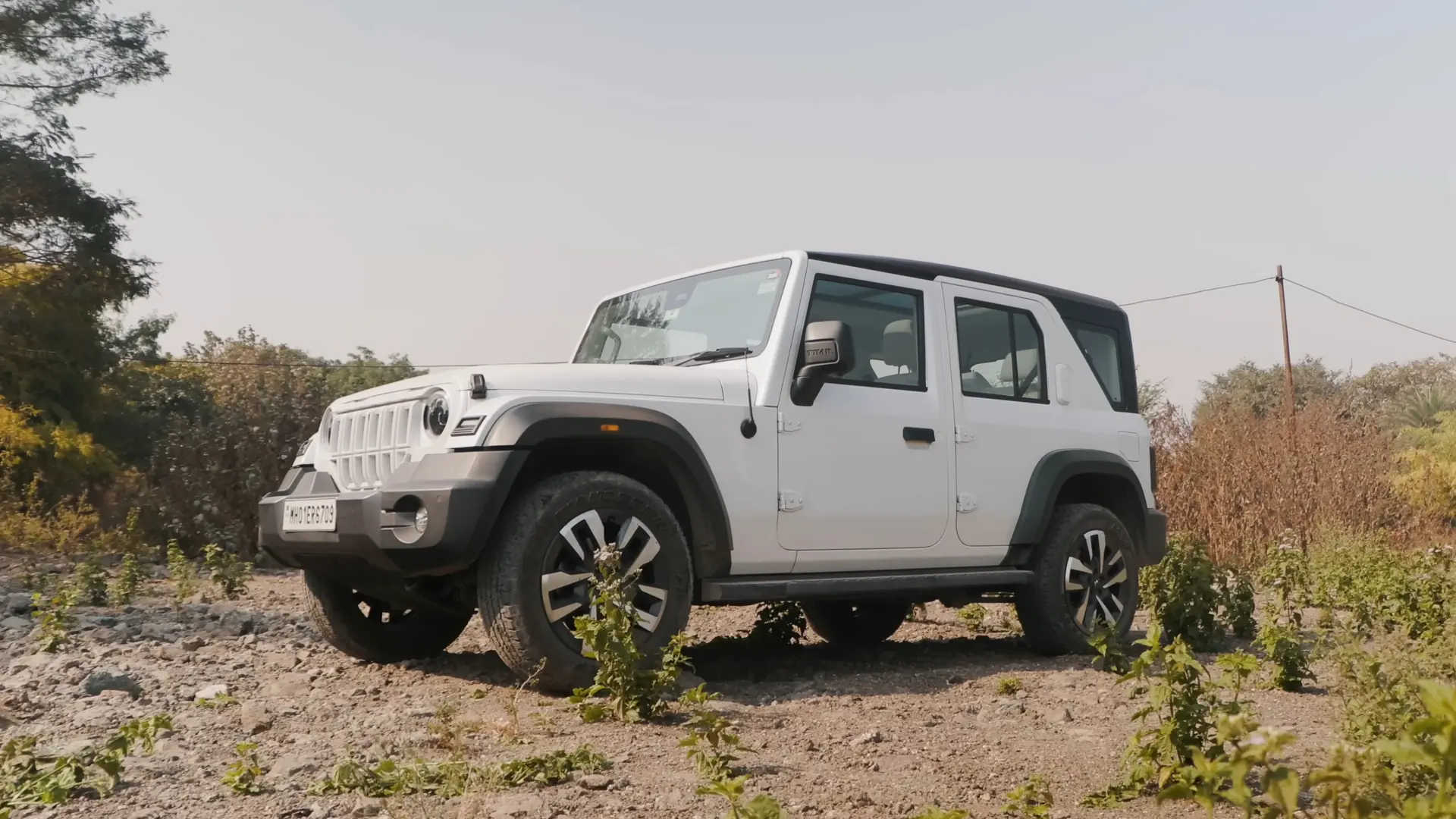White Mahindra Thar Roxx five-door SUV on a dirt track