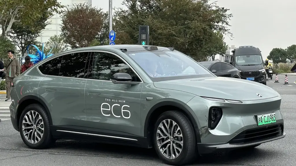 Green NIO EC6 coupe SUV on a street