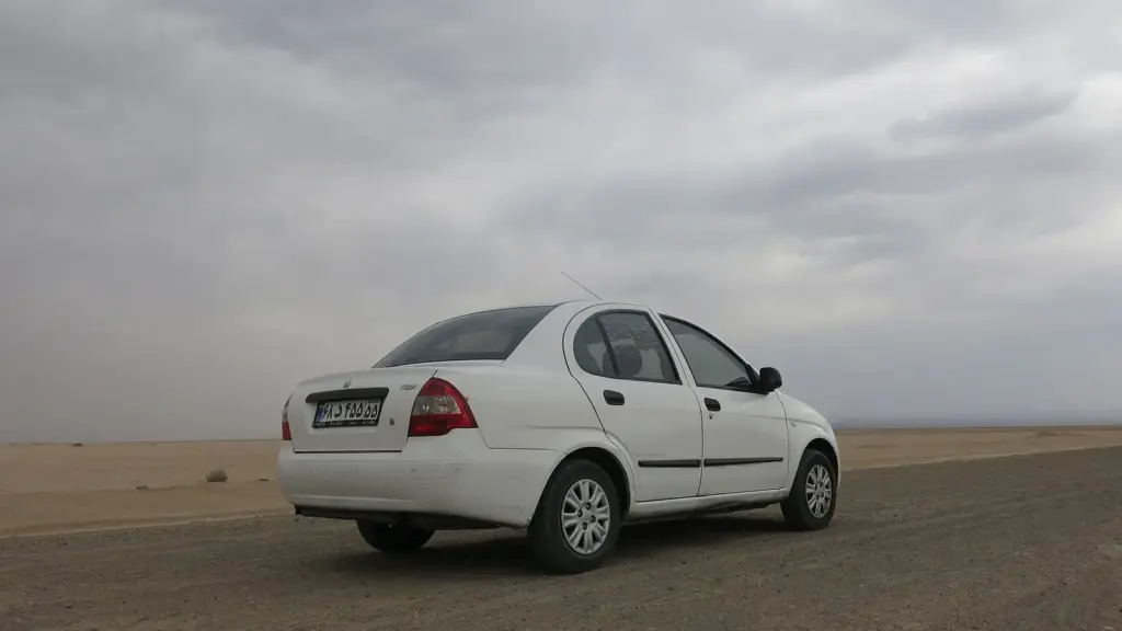 White Saipa Tiba sedan parked on open ground