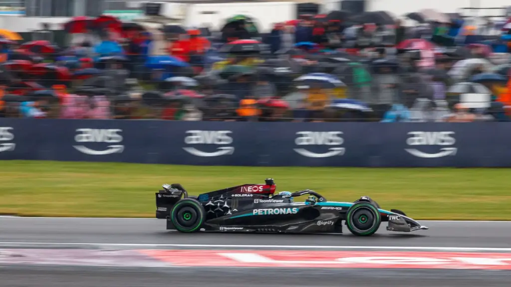 A Mercedes Formula 1 car during the 2024 British Grand Prix at Silverstone, with fans in the grandstand behind