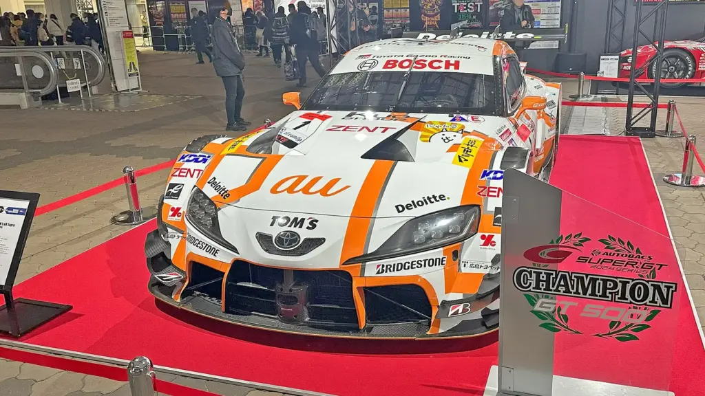 The No. 36 au TOM'S Toyota GR Supra that won the 2024 GT500 title, on display at Osaka Auto Messe 2025