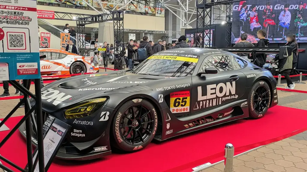 The 2025 GT300 champion No. 65 LEON PYRAMID Mercedes-AMG GT3 on display at Osaka Auto Messe 2026