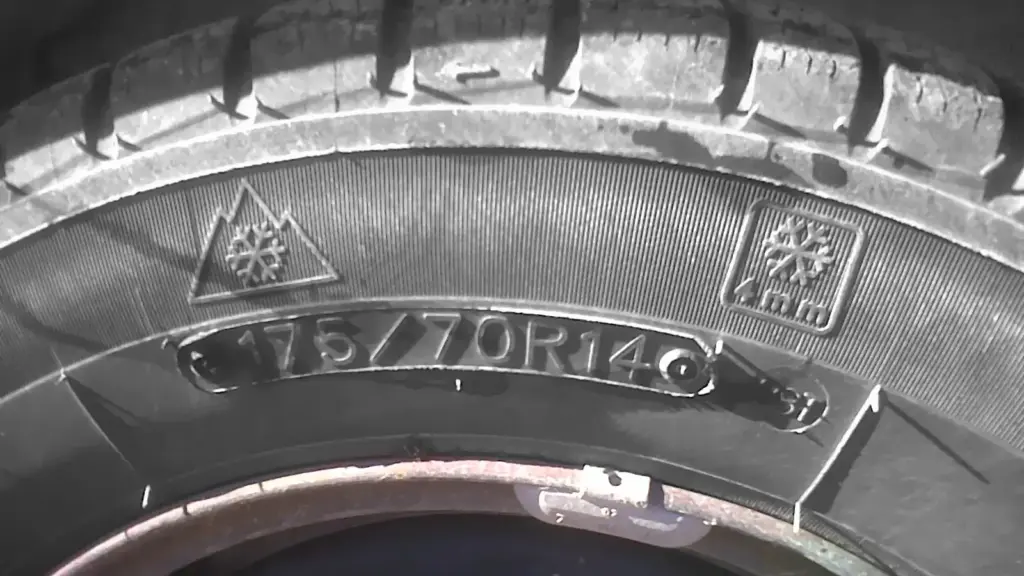 Tire sidewall showing the size code 175/70R14 next to the mountain snowflake symbol