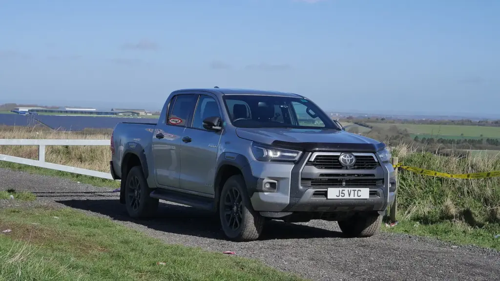 Gray eighth-generation Toyota Hilux Invincible X double cab parked by the coast