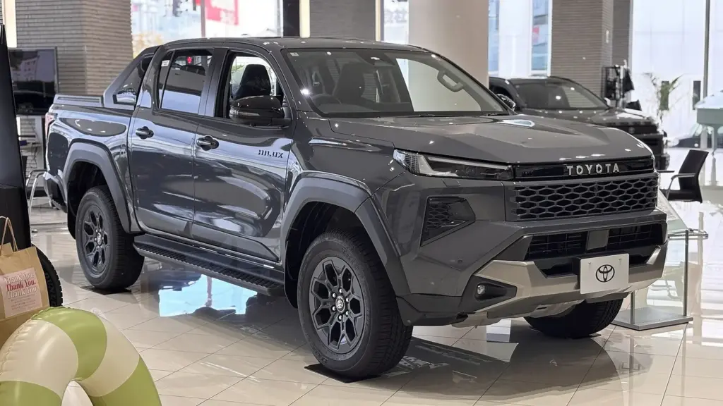 Dark gray ninth-generation Toyota Hilux Z Adventure double cab in a showroom