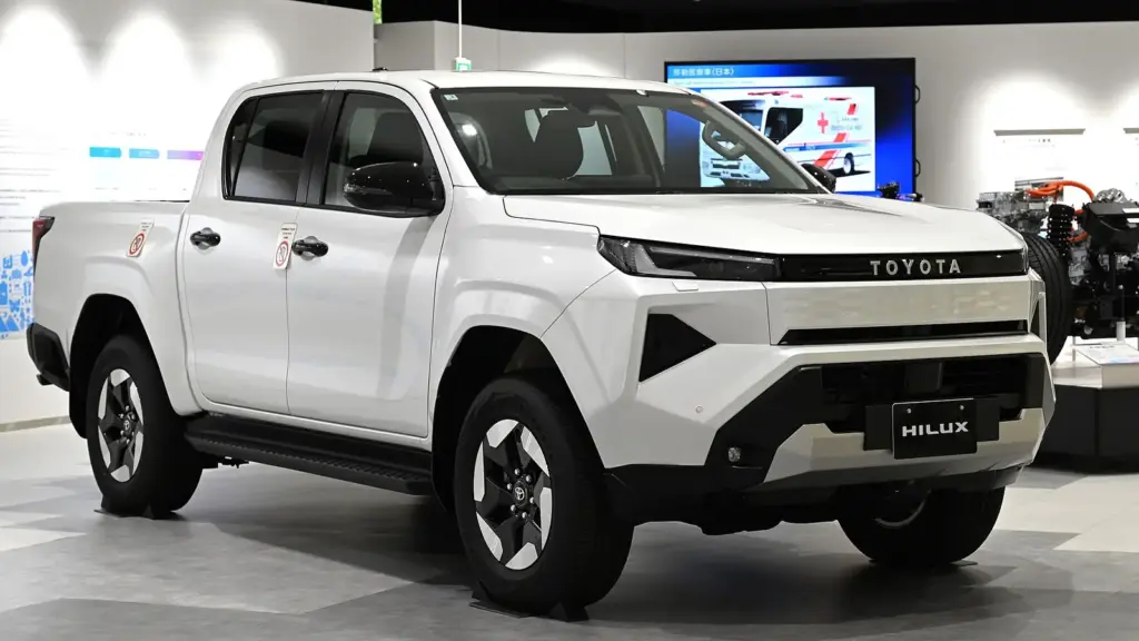White ninth-generation Toyota Hilux BEV electric double cab on display