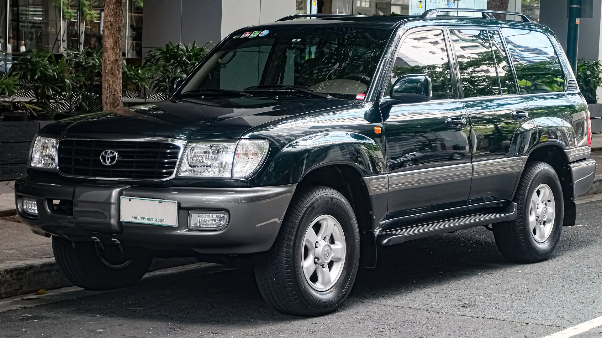 Dark green Toyota Land Cruiser 100 Series VX-R with the 4.7 V8, front three-quarter view