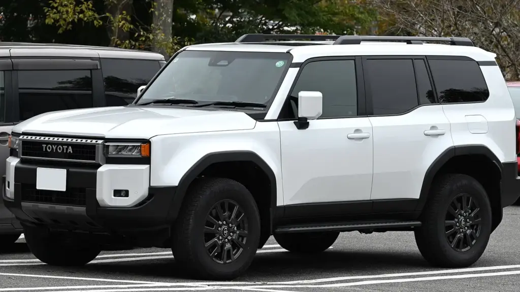 White Toyota Land Cruiser 250 VX with rectangular LED headlights, parked in Japan