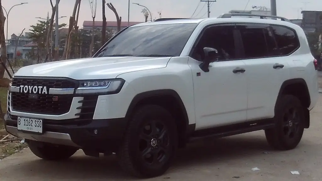 White Toyota Land Cruiser 300 GR Sport with its black TOYOTA grille, parked in Jambi City, Indonesia