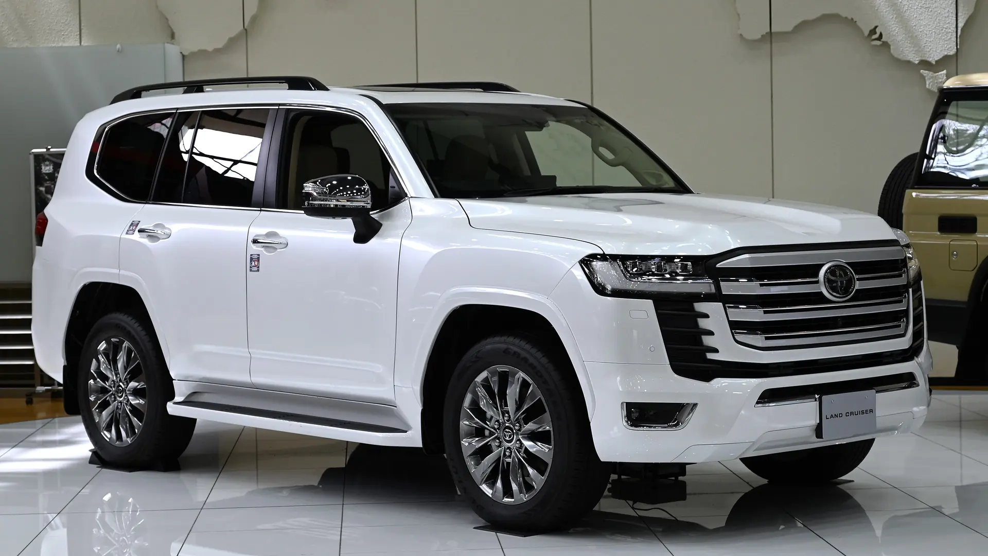 White 2021 Toyota Land Cruiser 300 ZX on display in a Toyota showroom in Japan