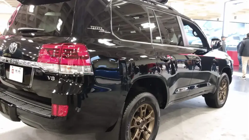 Black 2020 Toyota Land Cruiser Heritage Edition with bronze wheels, rear three-quarter view