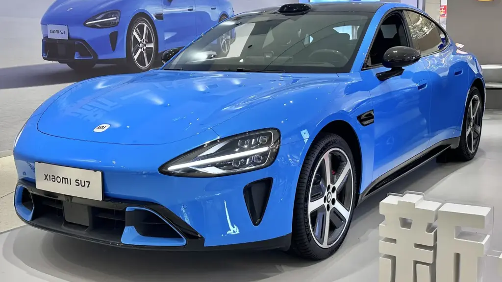 Blue new-generation Xiaomi SU7 sedan on display in a showroom