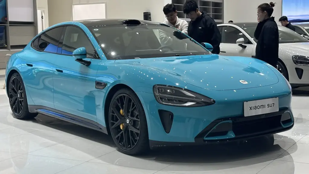 Light blue first-generation Xiaomi SU7 Max sedan in a showroom